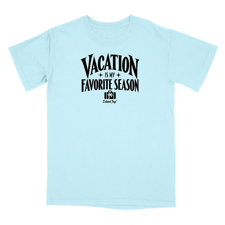 A light blue short-sleeve t-shirt with a black graphic print on the front that reads 'VACATION IS MY FAVORITE SEASON' with a small camera logo and 'Kalamaya' underneath, displayed on a clean white background.