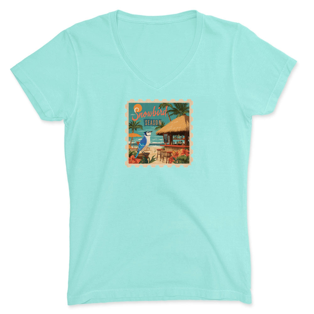 Mint green t-shirt with a tropical graphic on a white background