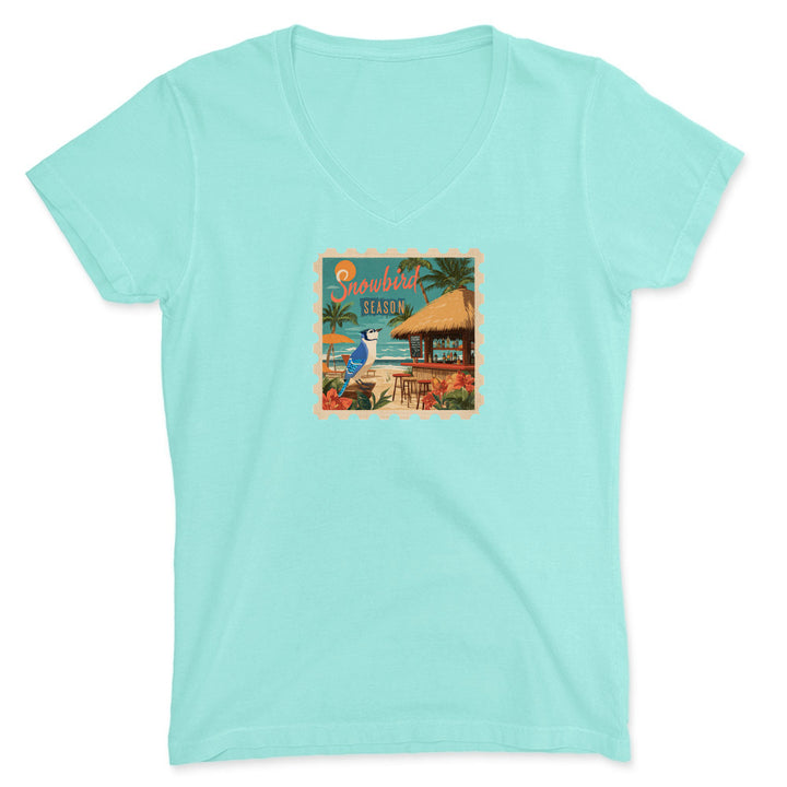 Mint green t-shirt with a tropical graphic on a white background