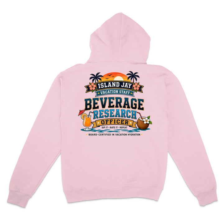 A light pink hooded sweatshirt shown from the back, featuring a colorful graphic print with palm trees, a sunset, and tropical drink illustrations above the text 'ISLAND JAY BEVERAGE RESEARCH OFFICER'.