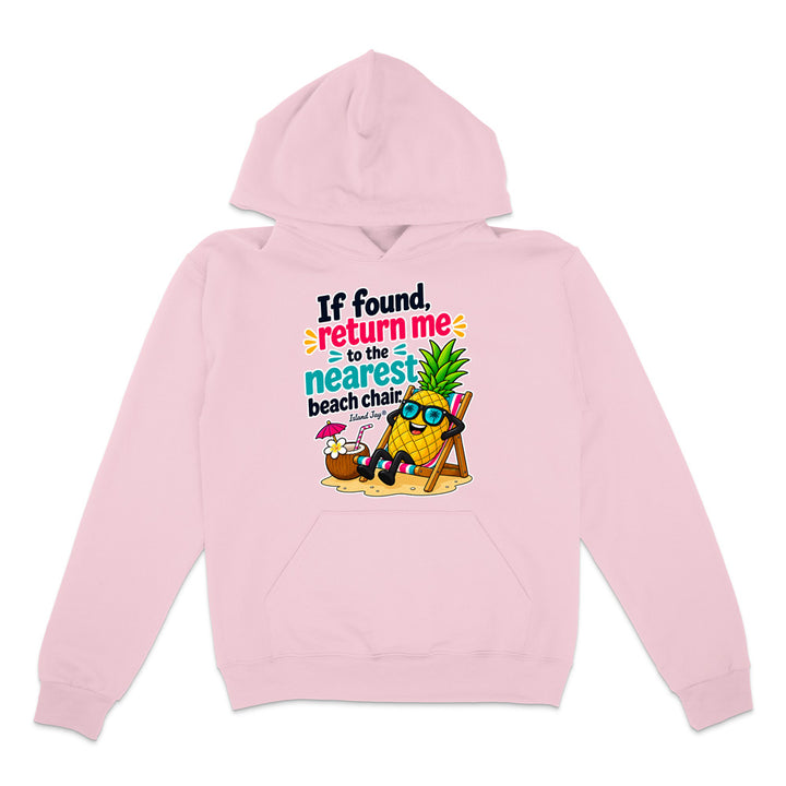 A light pink pullover hoodie with a colorful graphic on the chest. The graphic features a cartoon pineapple wearing sunglasses and relaxing in a beach chair next to a cocktail umbrella, with the text 'If found, return me to the nearest beach chair' in black, blue, and pink lettering.