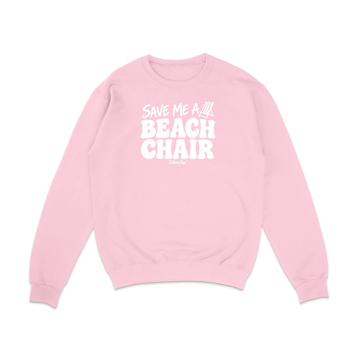 A light pink crewneck sweatshirt with a white graphic print on the front reading 'SAVE ME A BEACH CHAIR'