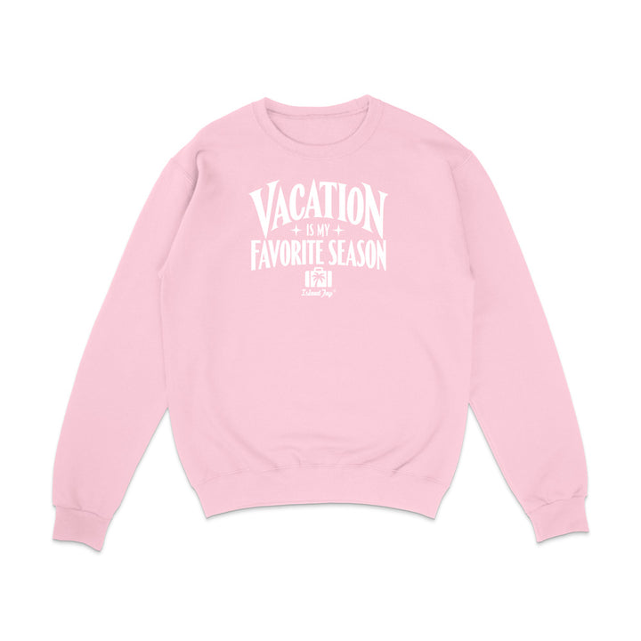 A light pink crewneck sweatshirt with a white graphic text print on the front that reads 'VACATION IS MY FAVORITE SEASON' with a small 'TooLoud' brand logo underneath, displayed on a clean white background.