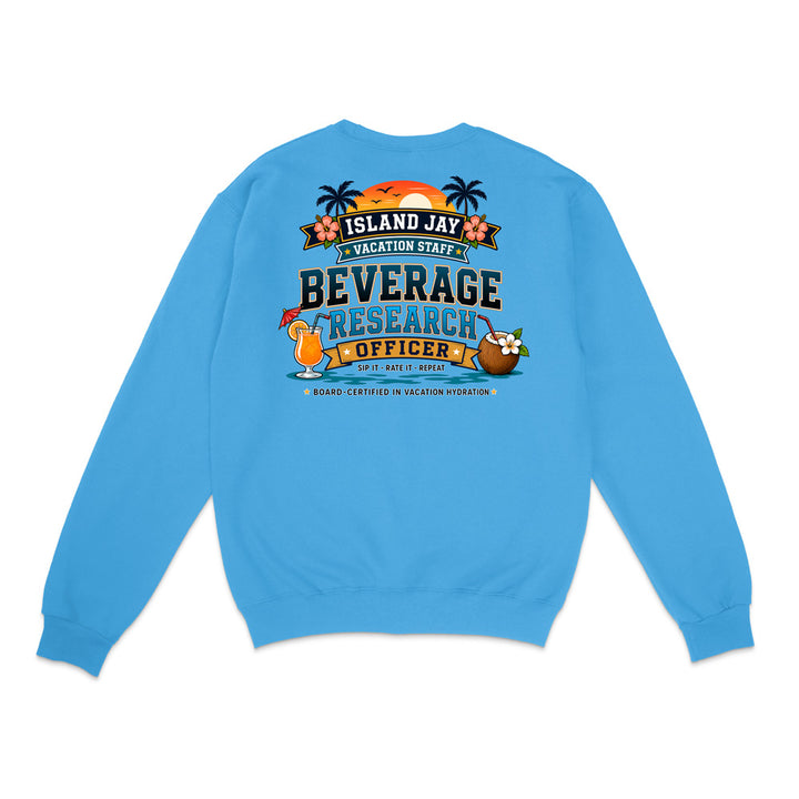 A bright blue crewneck sweatshirt shown from the back, featuring a colorful graphic print with tropical island elements and the text 'ISLAND JAY BEVERAGE RESEARCH OFFICER'.