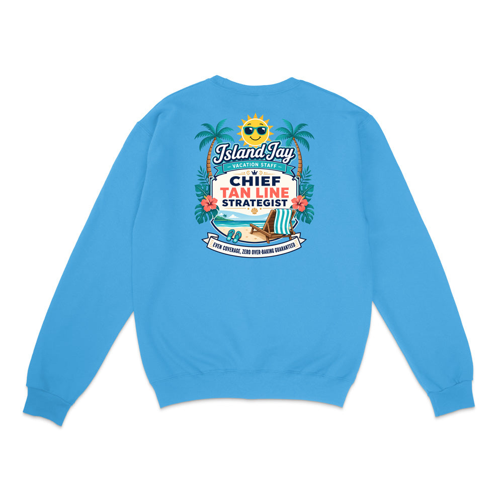 A bright blue crewneck sweatshirt shown from the back, featuring a colorful graphic print with palm trees, a beach chair, and text that reads 'IslandJazzy' and 'CHIEF TAN LINE STRATEGIST'.