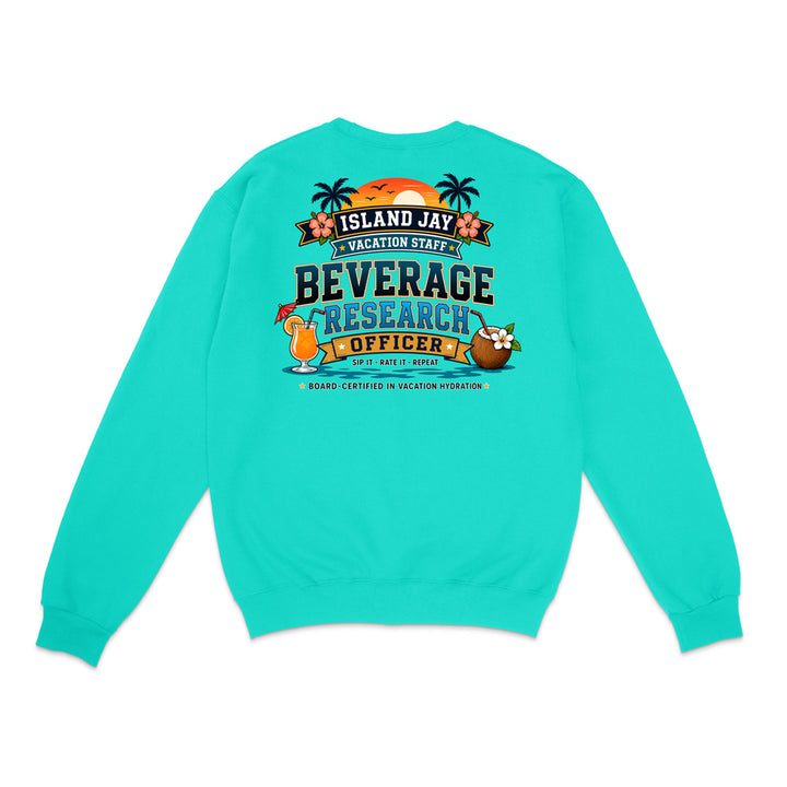 A turquoise crewneck sweatshirt shown from the back, featuring a colorful graphic print with tropical elements and the text 'ISLAND JAY BEVERAGE RESEARCH OFFICER'.