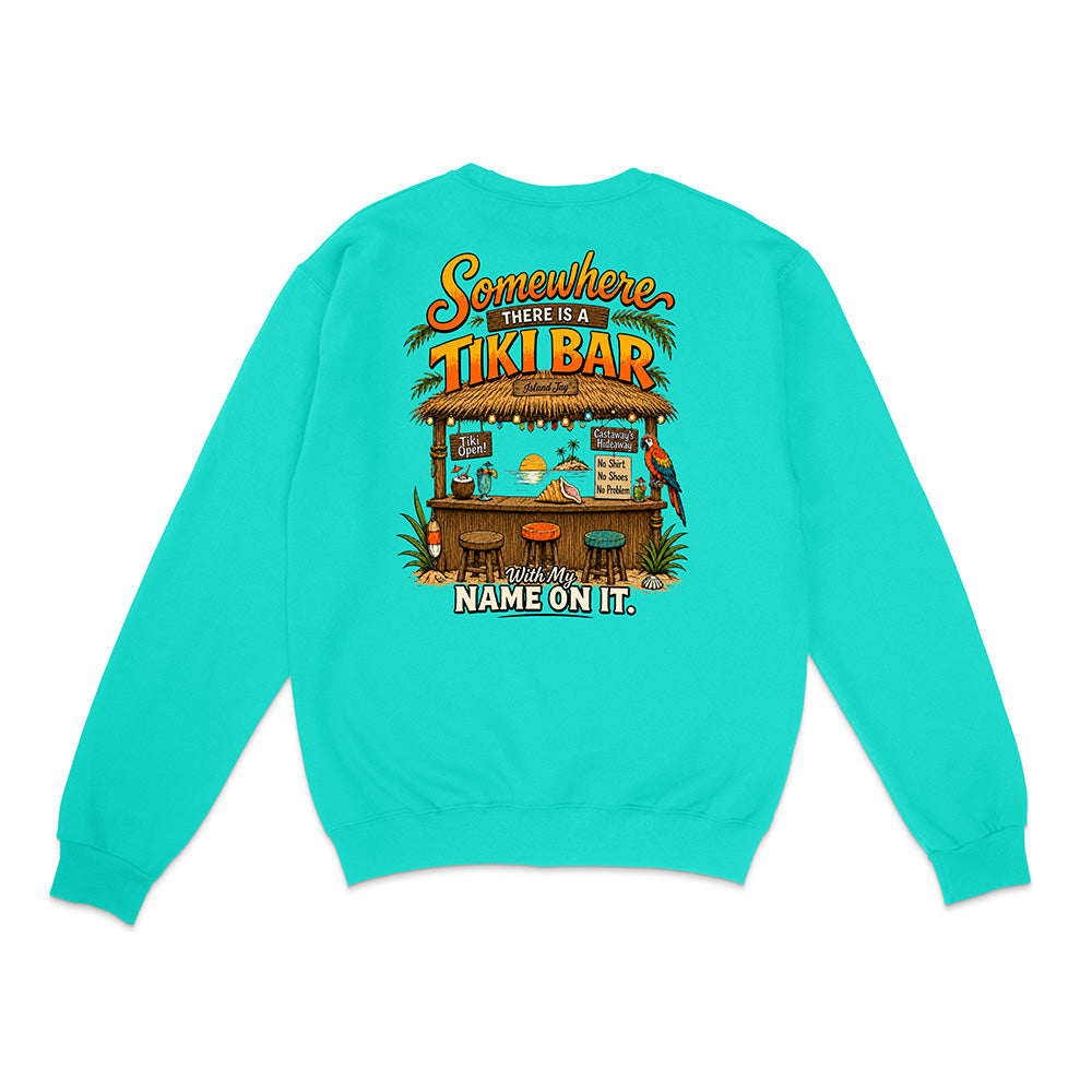 A turquoise crewneck sweatshirt shown from the back, featuring a colorful graphic of a tropical tiki bar with the text 'Somewhere THERE IS A TIKI BAR' and 'Wit My NAME ON IT.'.