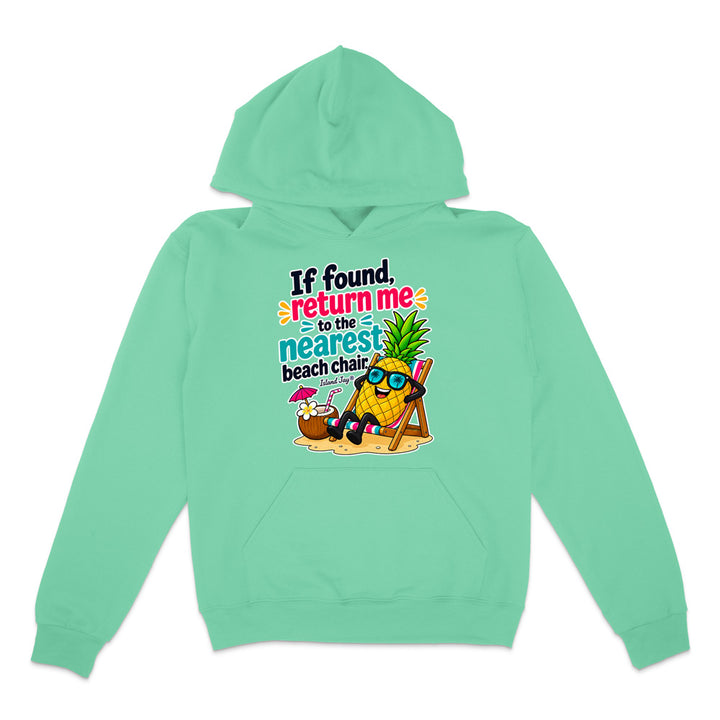 A mint green pullover hoodie with a colorful graphic on the chest featuring a pineapple character wearing sunglasses and reclining on a beach chair next to a cocktail, with the text 'If found return me to the nearest beach chair'.