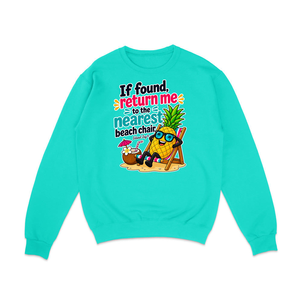 A turquoise crewneck sweatshirt with a colorful graphic on the front featuring a pineapple character wearing sunglasses and sitting in a beach chair next to a coconut drink, with the text 'If found, return me to the nearest beach chair'.