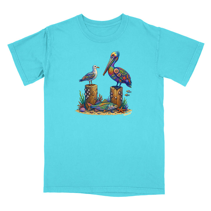 Turquoise t-shirt with a colorful pelican design on a white background
