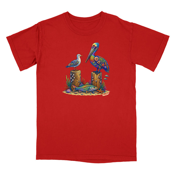 Red t-shirt with a colorful design of birds and fish on a white background
