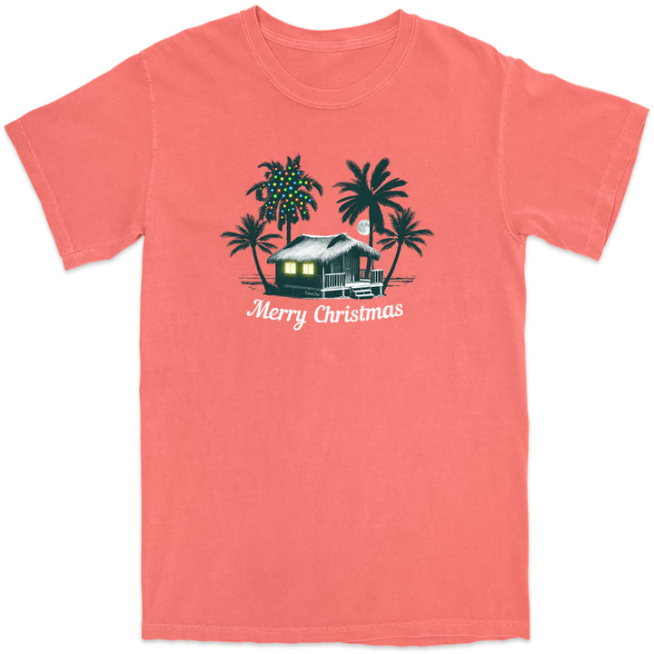 Deck the Palms: All Is Calm T-Shirt. Featuring a nighttime design of a beach house by the ocean with palm trees. One of the palm trees has christmas lights on it. In Coral color