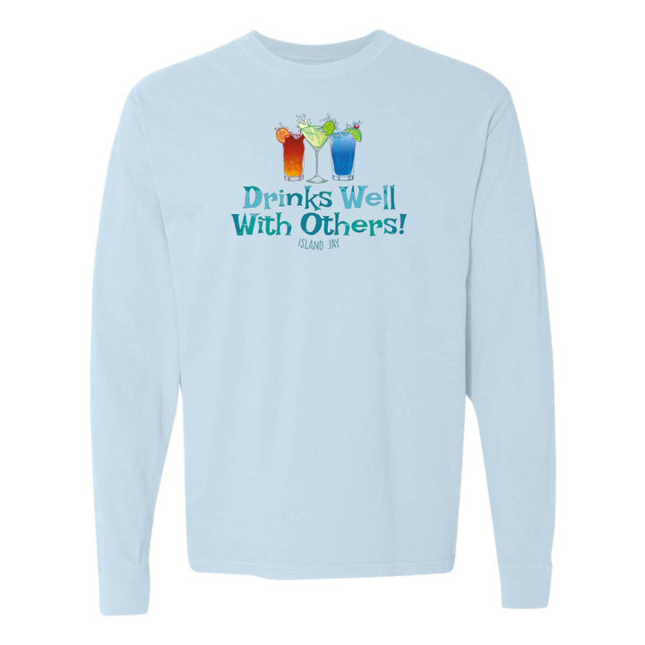Light blue long sleeve T-shirt with mixed drinks graphic and text reading "Drinks Well With Others!"
