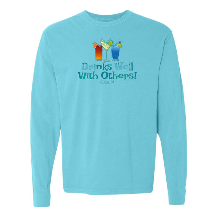 Blue long sleeve T-shirt with mixed drinks graphic and text reading "Drinks Well With Others!"