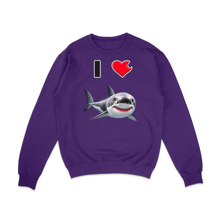 A purple crewneck sweatshirt featuring a graphic print of a great white shark and the text 'I' followed by a red heart, displayed on a clean white background.