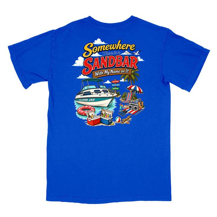 A royal blue short-sleeve t-shirt shown flat against a white background, featuring a colorful graphic print on the back with the text 'Somewhere SANDBAR With My Name on It' and illustrations of a boat, beach umbrella, and poolside scene.