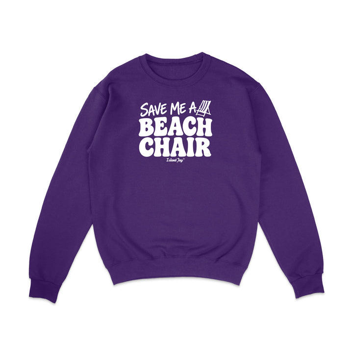 A purple crewneck sweatshirt with a white graphic print on the chest that reads 'SAVE ME A BEACH CHAIR' 