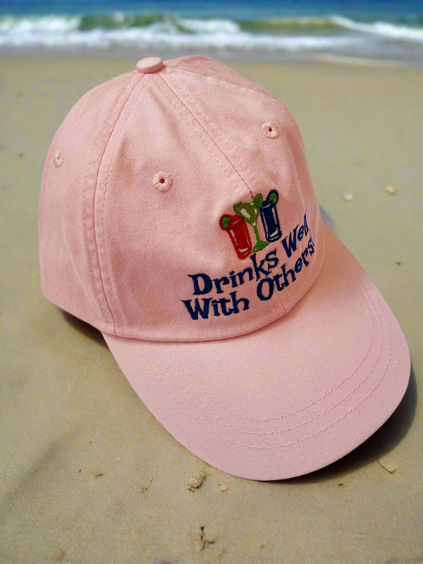 Drinks well with others, light pink hat