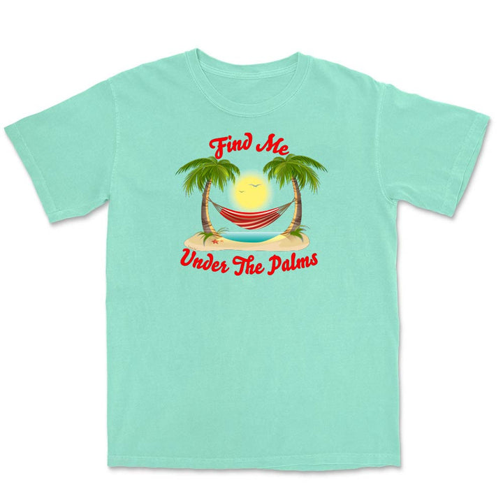 Light green t-shirt with a tropical graphic and text 'Find Me Under The Palms' on a white background