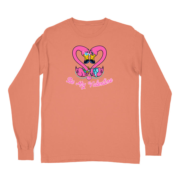 Coral long-sleeve shirt with cartoon flamingos and 'Be My Valentine' text on a white background