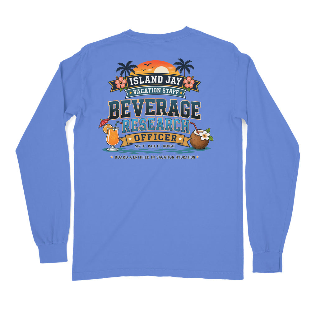 A light blue long-sleeve t-shirt shown from the back, featuring a colorful graphic print with tropical beach elements and the text 'ISLAND JAY VACATION STAFF BEVERAGE RESEARCH OFFICER'.
