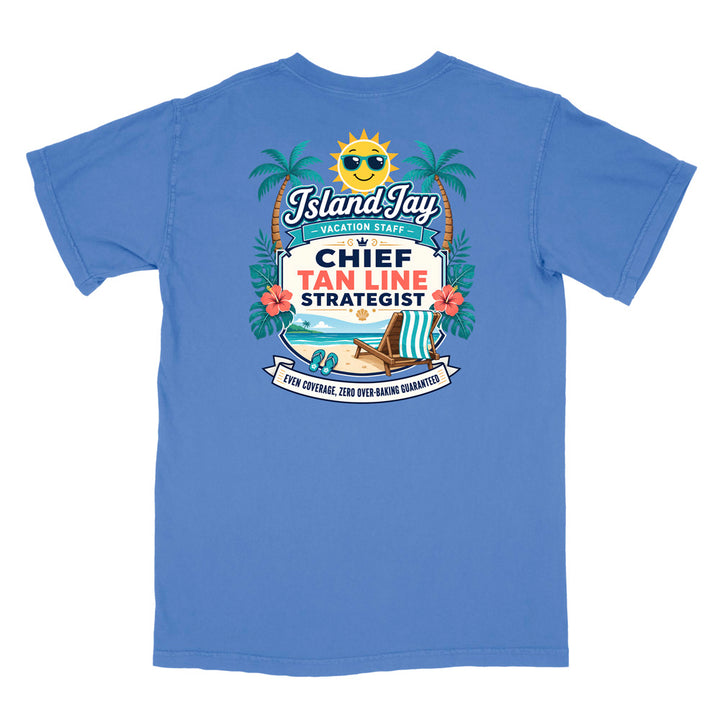 A blue short-sleeve t-shirt with a colorful graphic print on the front. The graphic features a smiling sun wearing sunglasses, palm trees, a beach scene, and text that reads 'Island Jay Vacation Staff by CHIEF TAN LINE STRATEGIST'.