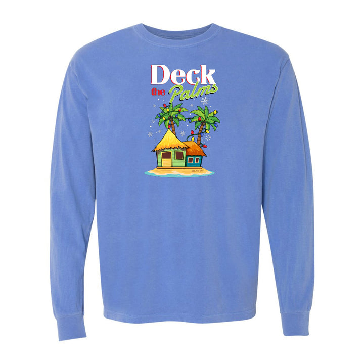 Blue long-sleeve shirt with a tropical hut and palm tree design and graphic text reading "Deck The Palms" on a white background