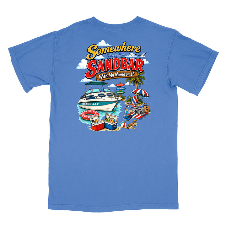A blue short-sleeve t-shirt shown flat against a white background, featuring a colorful graphic print on the back with the text 'Somewhere in the Sandbar' and a beach boat scene.