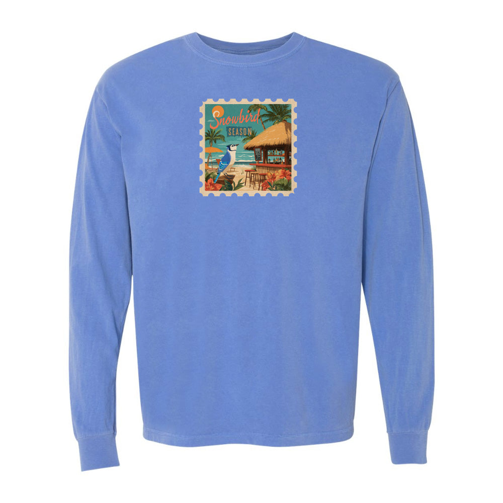 Blue long-sleeve shirt with a tropical graphic on a white background