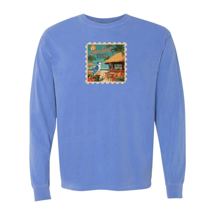 Blue long-sleeve shirt with a tropical graphic on a white background