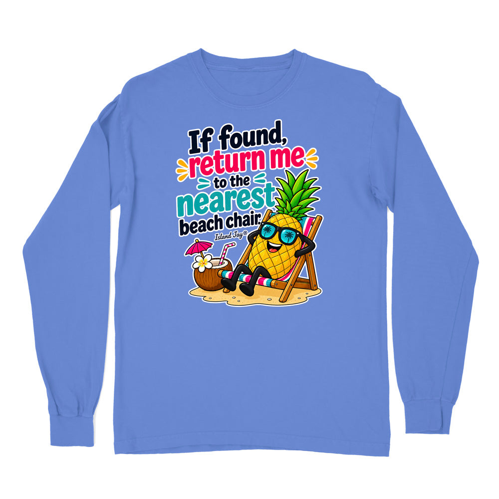 A light blue long-sleeve t-shirt with a colorful graphic print on the front. The graphic features a cartoon pineapple wearing sunglasses and relaxing in a beach chair next to a coconut drink, with the text 'If found, return me to the nearest beach chair.