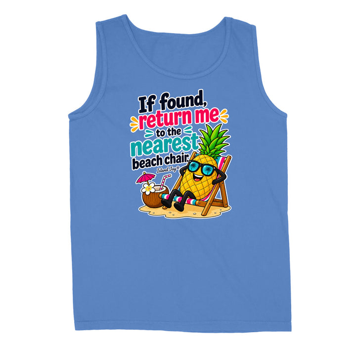 A blue sleeveless tank top with a colorful graphic on the front featuring a cartoon pineapple wearing sunglasses and reclining on a beach chair next to a coconut drink, with the text 'If found, return me to the nearest beach chair.'.