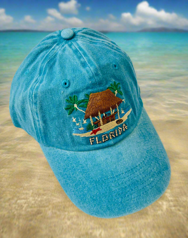 Blue baseball cap with the stitched image of a tiki bar on it with "Florida" stitched under the bar.