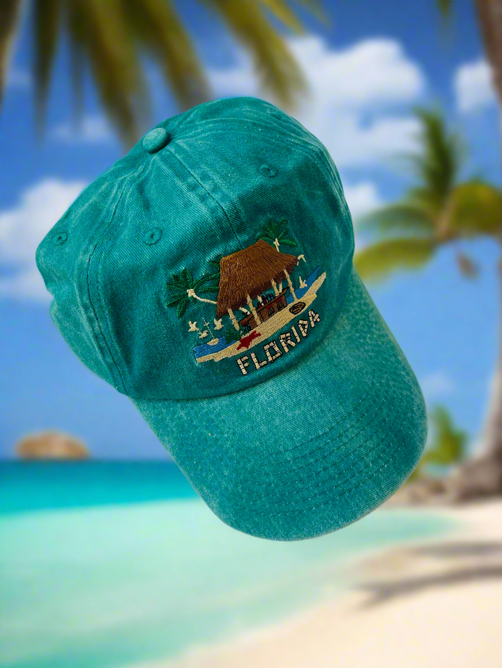 Green baseball cap with the stitched image of a tiki bar on it with "Florida" stitched under the bar.