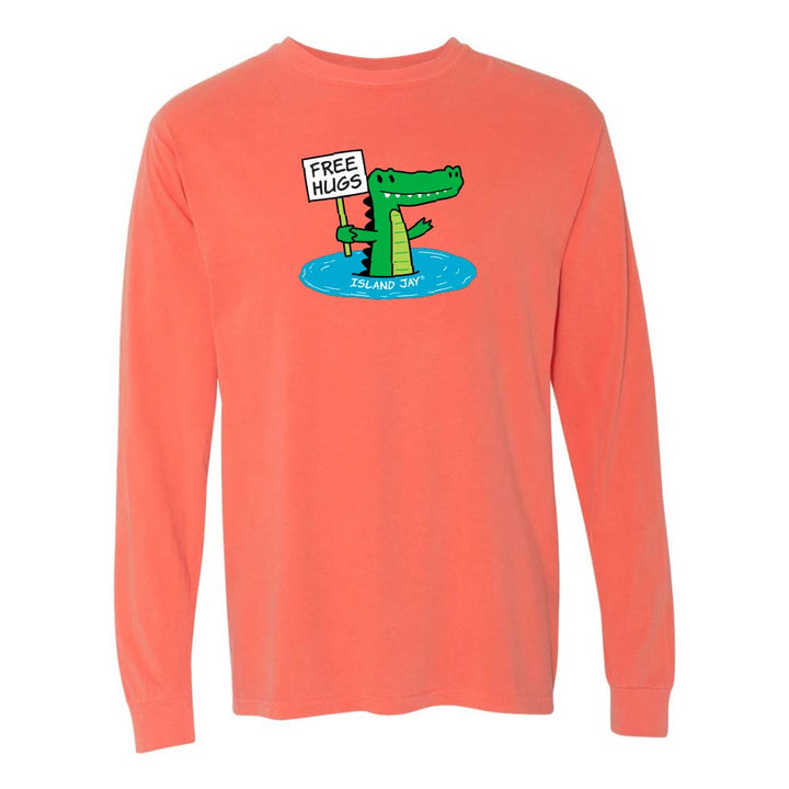 Light orange/red long-sleeve shirt with a cartoon alligator holding a 'Free Hugs' sign.