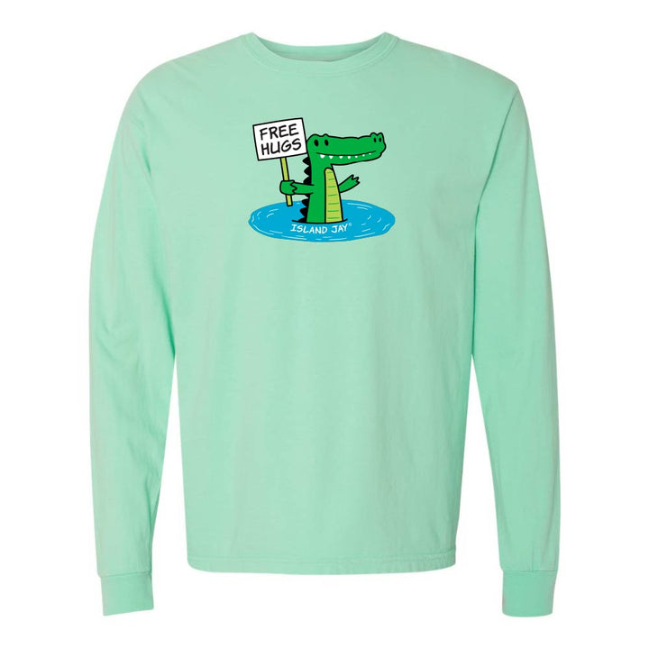Mint green long-sleeve shirt with a cartoon alligator holding a 'Free Hugs' sign.