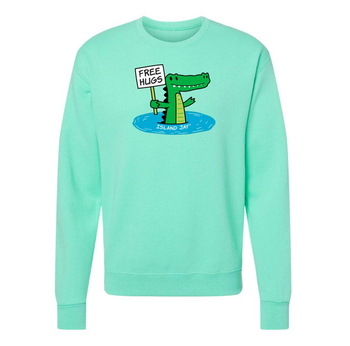 Mint green sweatshirt with a cartoon alligator holding a 'Free Hugs' sign on a white background