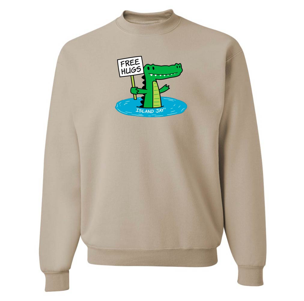 Beige sweatshirt with a cartoon alligator holding a 'Free Hugs' sign on a white background