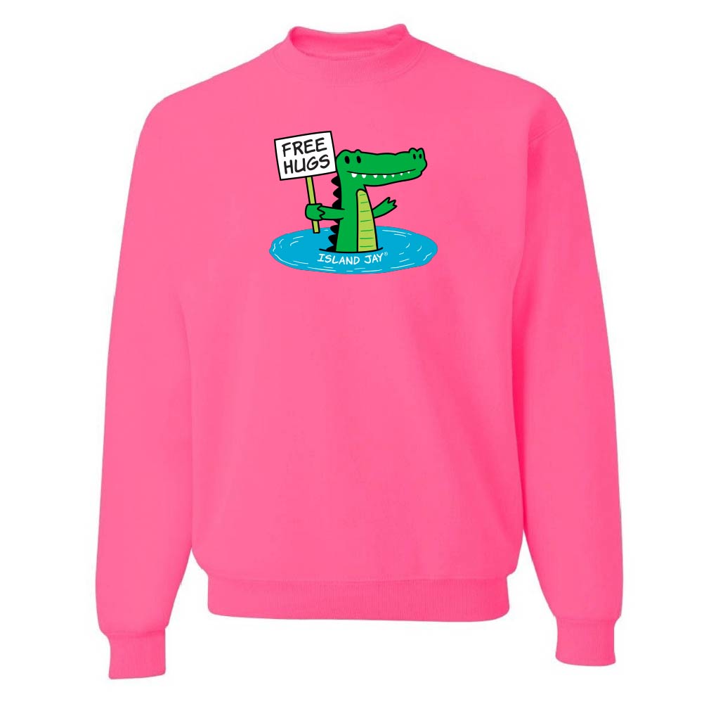 Pink sweatshirt with a cartoon alligator holding a 'Free Hugs' sign on a white background