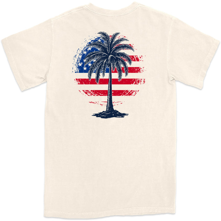 Freedom Shores T-Shirt. Am American Flag mixed with a tropical palm tree. Color Natural