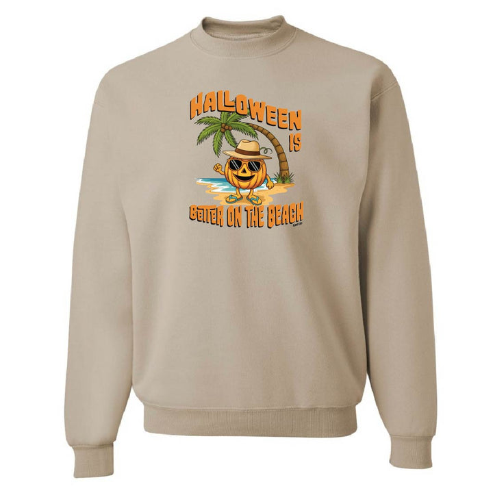 Beige sweatshirt with Halloween design featuring a pumpkin on a beach.