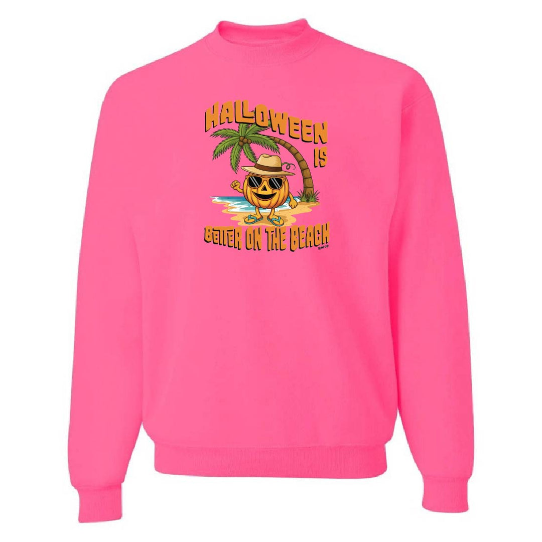 Pink sweatshirt with Halloween design featuring a pumpkin on a beach.