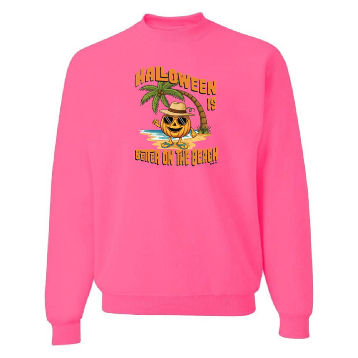 Pink sweatshirt with Halloween design featuring a pumpkin on a beach.