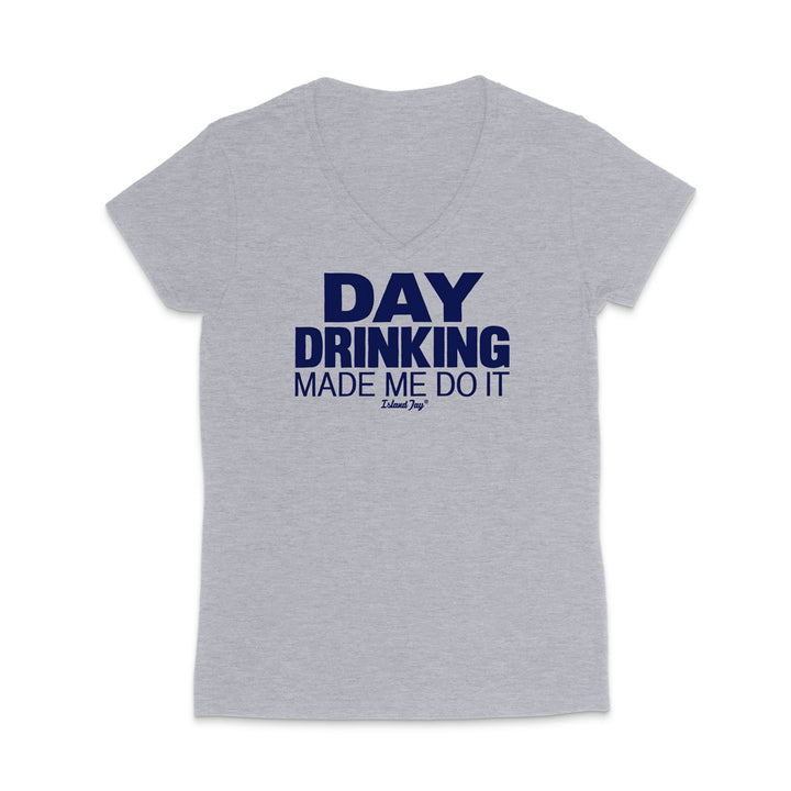 A light heather gray V-neck t-shirt with a dark navy blue graphic text reading 'DAY DRINKING MADE ME DO IT' and a small 'Edible Joy' logo underneath, displayed on a clean white background.
