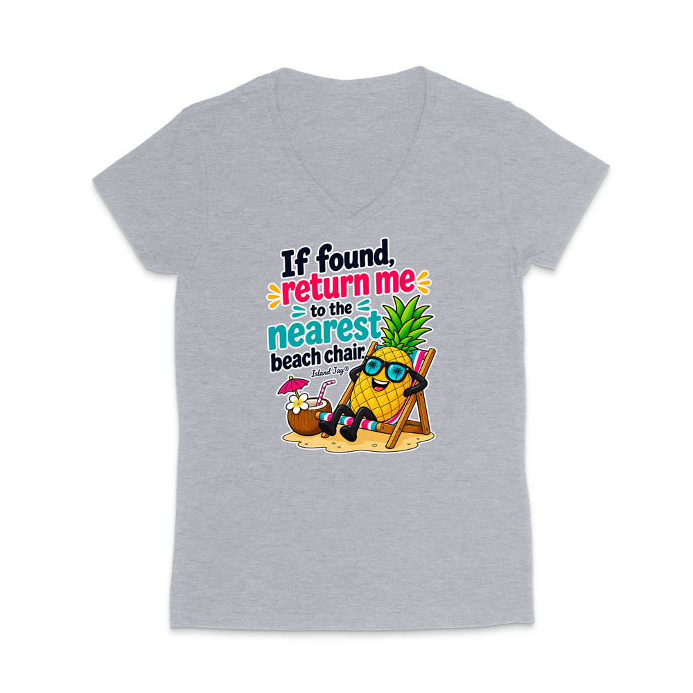 A heather gray women's V-neck t-shirt featuring a colorful graphic of a pineapple character wearing sunglasses and reclining on a beach chair next to a coconut drink, with the text 'If found, return me to the nearest beach chair.'.