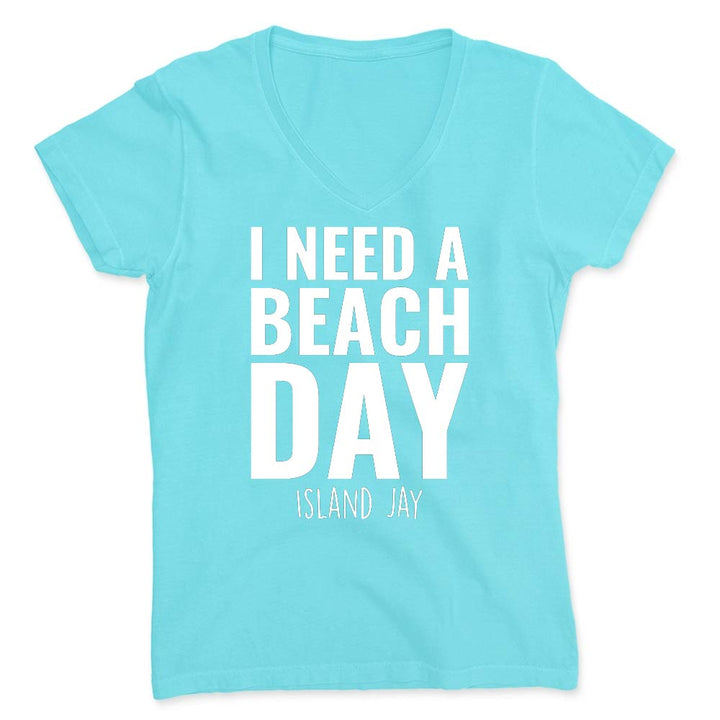 Light blue t-shirt with 'I NEED A BEACH DAY' text on a white background