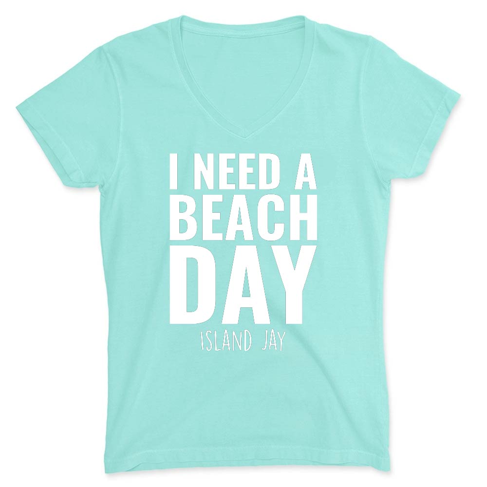 Mint green t-shirt with 'I NEED A BEACH DAY' text on a white background