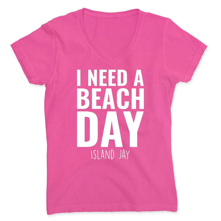 Pink t-shirt with 'I NEED A BEACH DAY' text on a white background