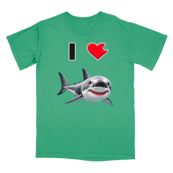 A green short-sleeve crewneck t-shirt featuring a graphic print of a shark and the text 'I' followed by a red heart and the shark, displayed on a solid white background.