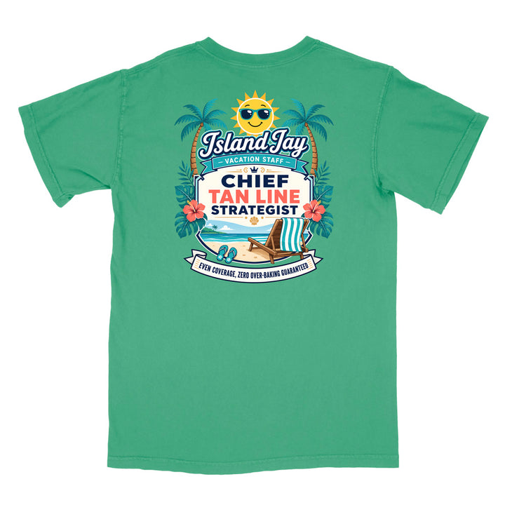 A green short-sleeve t-shirt with a colorful graphic print on the front. The graphic features a smiling sun wearing sunglasses, palm trees, a beach scene, and text that reads 'Island Jay Vacation Staff by CHIEF TAN LINE STRATEGIST'.